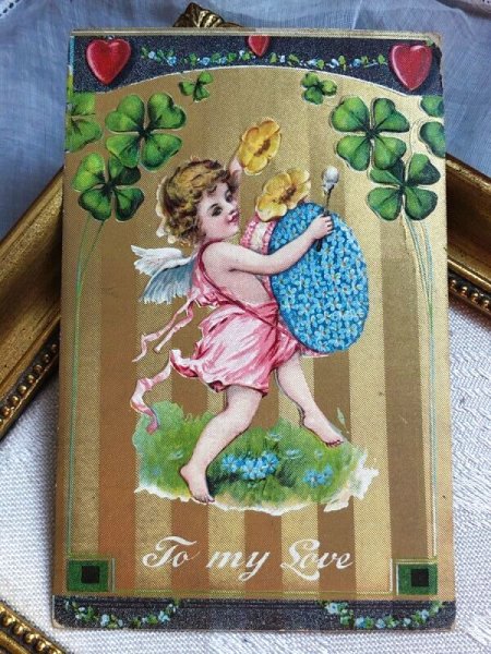 画像2: Postcard   アンティークポストカード バレンタイン 天使とお花の楽器 忘れな草のお花のドラム アメリカ1910年 (2)